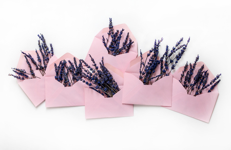 Isolated pink envelopes with blue flowers in it. Horizontal studio shotの写真素材