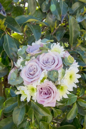 Bouquet of natural flowers with roses and green leavesの写真素材