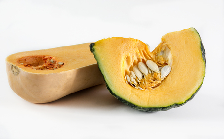 Raw pumpkin cut to pieces on white backgroundの写真素材