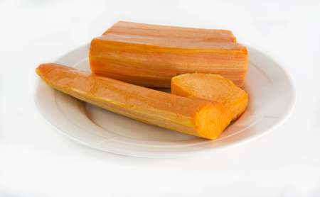 Raw pumpkin cut to pieces on white backgroundの写真素材