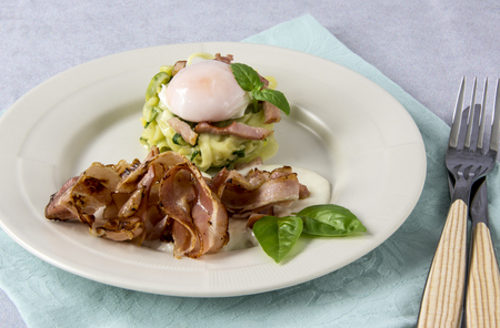Scrambled eggs with zucchini, carbonara sauce and baconの写真素材