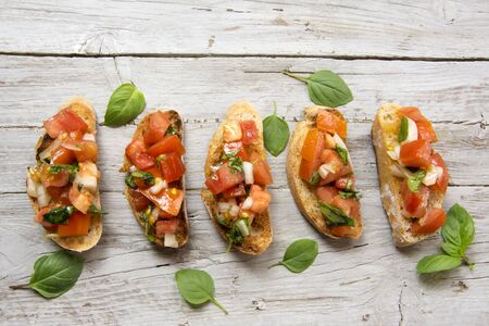 Bruscheta, antipasti Typical Italian with tomato, basil and toast