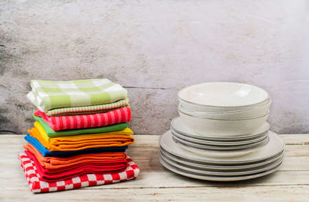 Kitchen towels with dishes on wooden table with a gray backgroundの写真素材