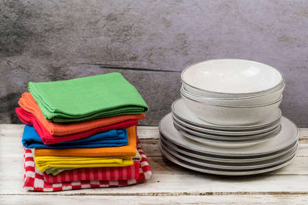 Kitchen towels with dishes on wooden table with a gray backgroundの写真素材