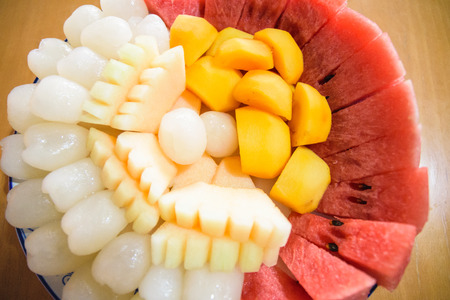 A fruit plateIncluding rambutan, watermelon, melon and persimmonの写真素材