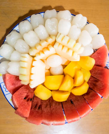 A fruit plateIncluding rambutan, watermelon, melon and persimmonの写真素材