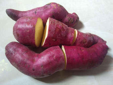 sweet pink potatoes on the white background close up photoの写真素材