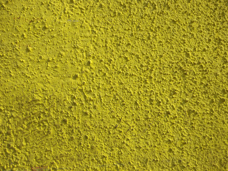 Exterior and interior dry yellow color plaster surface and texture close up photo.の写真素材