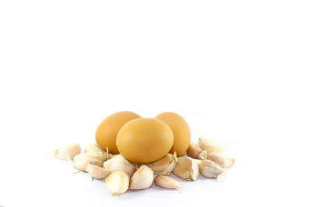Eggs with garlic  on White backgroundの写真素材