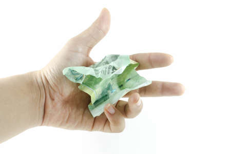 banknotes crumpled on a hand on White backgroundの写真素材