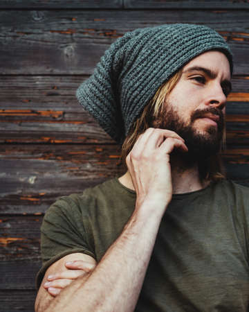 Portrait of young bearded man while he is looking the other sideの写真素材
