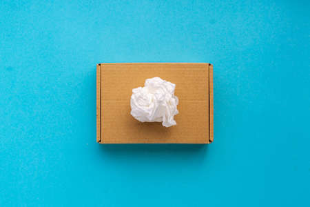 Cardboard box with cotton paper on top on a blue background Concept recycle garbage to the blue...
