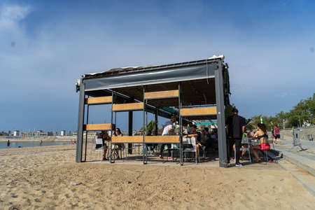 BARCELONA; SPAIN - MAY 25th 2020: First day of the phase 1 of the coronavirus disease (COVID-19) in Barcelona, one of the few beach bars open on the beaches of Barcelonaのeditorial素材