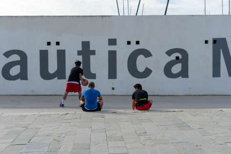 BARCELONA; SPAIN - MAY 25th 2020: First day of the phase 1 of the coronavirus disease (COVID-19) in Barcelona, three young people taking advantage of the hours allowed to play basketballのeditorial素材