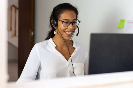 Working brazilian young woman in bedroom. Telemeeting. Video conference. Remote work. Call center...