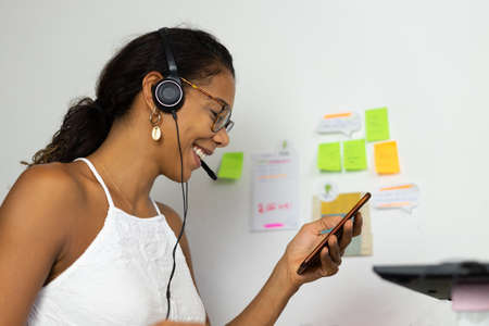 Working brazilian young woman in bedroom. Telemeeting. Video conference. Remote work. Call center...