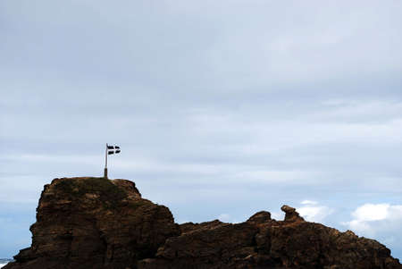 Royalty Free Stock Image of a photograph of the flag on the Perranporth coast against a cloudy sky providing copyspace aboveの写真素材