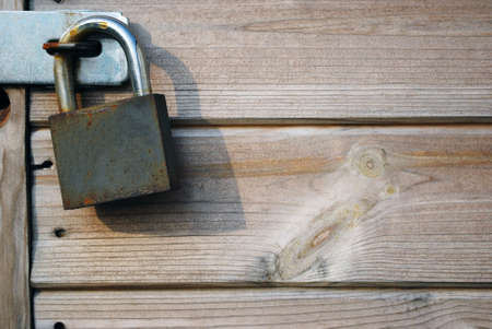 Padlock to left against wood with copy spaceの写真素材