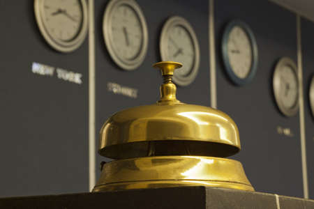 old hotel bell with watch in backgroundの写真素材
