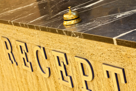 old hotel bell on a marble standの写真素材