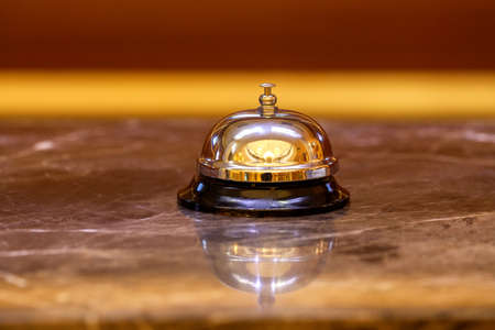 old hotel bell on a marble standの写真素材