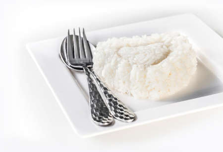jasmine rice on dish with spoon and fork, ready to eatの写真素材