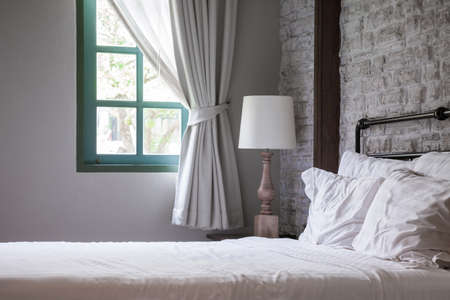 white pillows and blanket on bed in the morning shine, bedroom