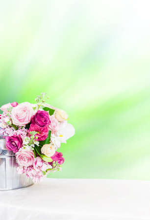 floral bucket on the table with copy space, flower in bucketの写真素材