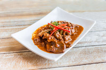 Thai food, beef in ground peanut coconut cream curry on white plateの写真素材