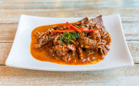 Thai food, beef in ground peanut coconut cream curry on white plateの写真素材