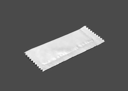 blank packaging sugar foil sachet isolated on gray background with clipping pathの写真素材
