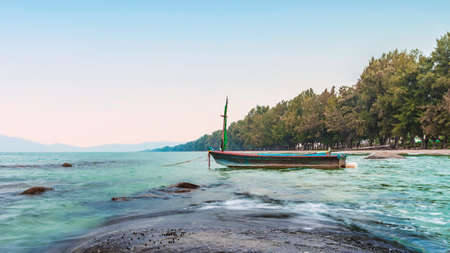 sea in the morning sunrise with small fishing boat, rayong province thailandの写真素材