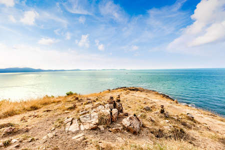 Beautiful seascape with rocks and meadow in cloudy blue sky at Khao Leam Ya National Park, Rayong province Thailandの写真素材