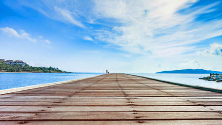 Wooden plank pier with seascape and bright blue sky for relax time at Khao Leam Ya National Park, Rayong Province, Thailandの写真素材