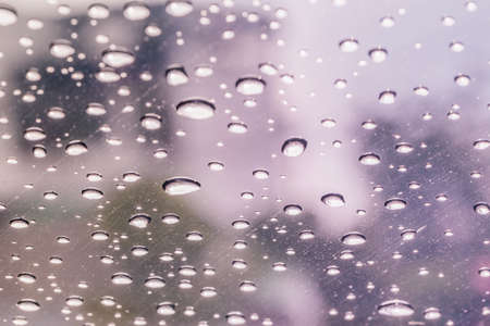 Raindrops on a car windshield after raining, raining seasonの写真素材