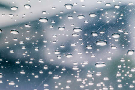 Raindrops on a car windshield after raining, raining season