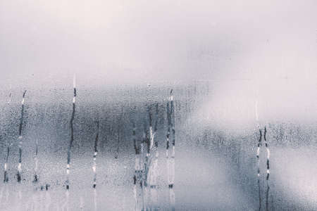 raindrops on glass window in rainy season with monotoneの写真素材