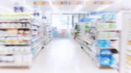 Supermarket aisle with colorful shelves and many products as blurred backgroundの写真素材