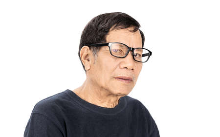 old wrinkled asian man portrait with eye glasses and navy blue T-shirt isolated on white backgroundの写真素材
