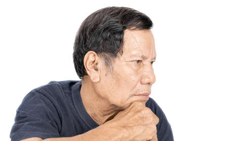 old wrinkled asian man portrait with serious mood and wear navy blue t-shirt isolated on white backgroundの写真素材
