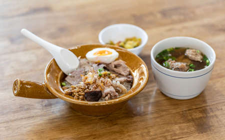 thai delicious meal, cooked rice with boiled egg, pork ribs soup, fried garlic and other side dishes...