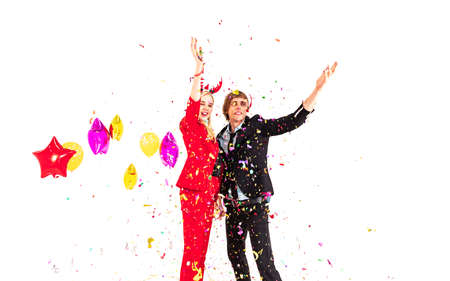 young people man and woman enjoy with colorful confetti in new year celebration hangout party and isolated on white backgroundの写真素材