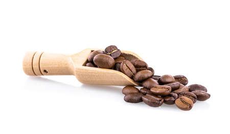 Fresh coffee beans in wooden spoon ready for rosted and brew a cup of coffee isolated on white backgroundの写真素材