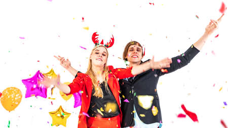 young couple enjoy dance with colorful confetti in new year celebration hangout party and isolated...