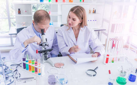 Two scientists working and discus in chemical laboratory, teamwork analysis and scientist working conceptの写真素材