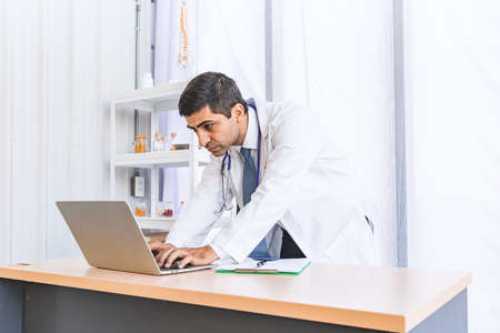 Asian doctor in gown uniform working in seriously at hospital or medical clinic, Healthty and Occupation conceptの写真素材