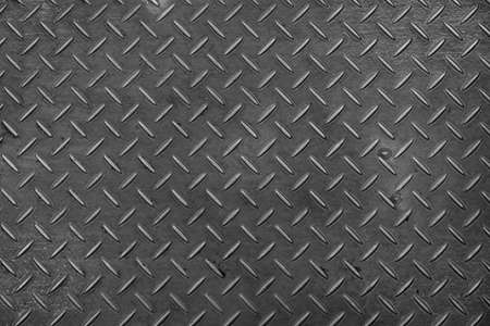 Metal Plate textured with rhombus shapes, dark dirty metal background or steel surfaceの写真素材