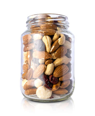 Clear glass bottle with mixed nuts healthy organic food isolated on white backgroundの写真素材