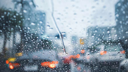 driving car on road in the rain with raindrop over the wind shield, traffic jam in rainy seasonの写真素材