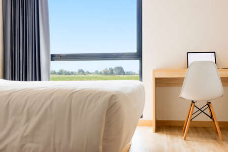 work space in modern interior bed room with laptop or notebook on wooden desk, work from home conceptの写真素材